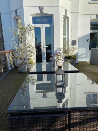 a clock on a glass table in front of a building at The White House Hotel in Newquay