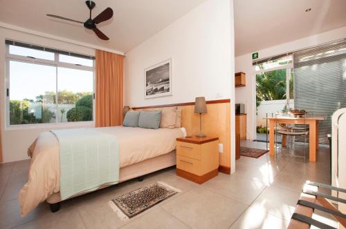 - une chambre avec un lit, un bureau et une fenêtre dans l'établissement Palamos on Sea, à St Francis Bay
