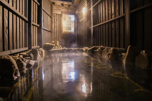 an empty room with a pool of water in a barn at Yufu-no-yu Shiki Iyashi in Yufuin
