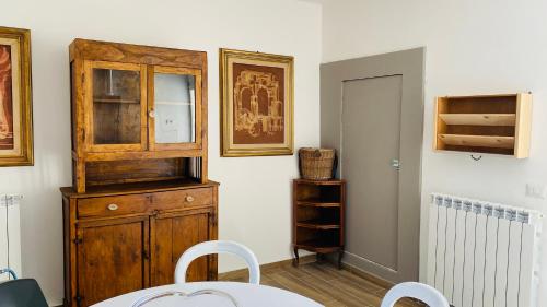 a room with a wooden cabinet and a table at Agriturismo Casa Orsini in Montefalco