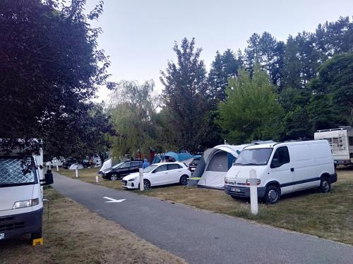 a group of cars and tents in a parking lot at Camping du lac in Saint-Julien-du-Verdon