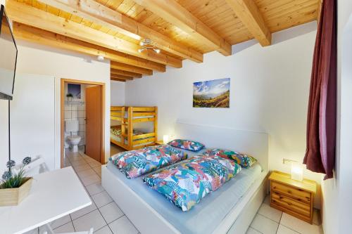 a bedroom with a bed and a wooden ceiling at Gästehaus Viktoriya nur wenige Minuten zum Europa-Park in Rust
