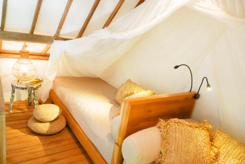 a small room with a bed in a house at Amar Boutique Hotel in Canggu