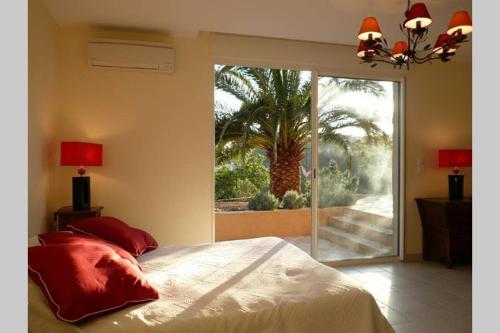 a bedroom with a bed and a large sliding glass door at Lou Pei 2 Superbe vue mer Piscine chauffée 10x5m Version 3ch 3sdb in Saint-Peïre-sur-Mer