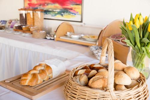 a table with two baskets of bread and pastries at Hotel Metropol in Widnau