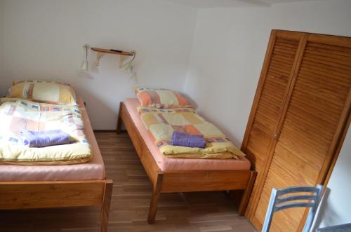 two beds sitting next to each other in a room at Apartmány Kosmonosy, Hradištská 181 in Mladá Boleslav