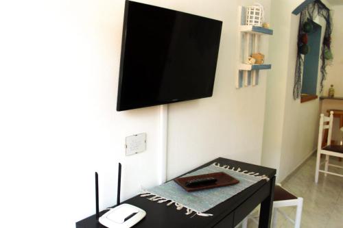 En tv och/eller ett underhållningssystem på Appartamento Corralejo