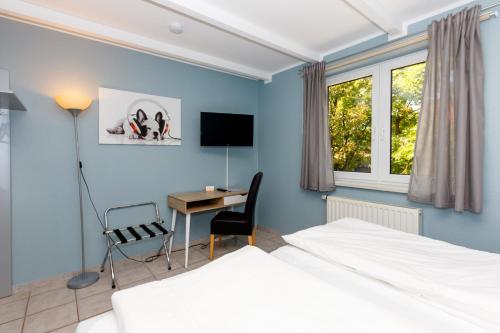 Кровать или кровати в номере Apart Hotel Sarstedter Hof