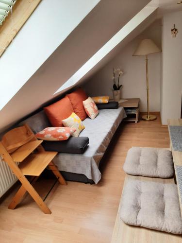 una sala de estar con sofá en el ático en Apartma Vrh en Lesce