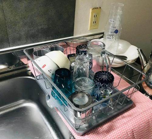 Miyoshiにあるエバーガーデンの皿棚(シンクに皿とガラス瓶付)