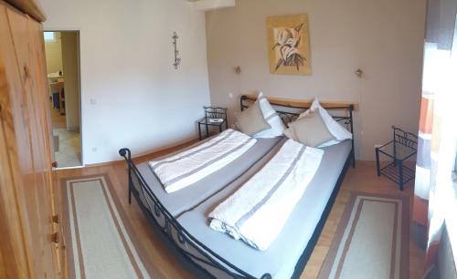 a bedroom with a bed with white sheets and pillows at Ferienwohnung -Zur Sonnenleite- in Dörfles-Esbach