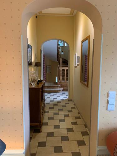 a hallway with an archway leading into a house at L'Étape Fagnarde - Bed, Breakfast & Sauna in Spa