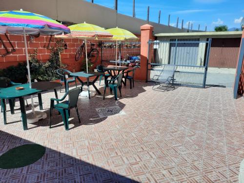 a patio with tables and chairs and umbrellas at B&B Confine in Como