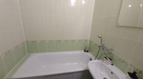 a bathroom with a bath tub and a toilet at Comfort House бульвар Олександрійський 125 in Bila Tserkva