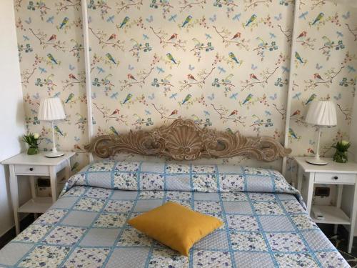 una camera da letto con un letto con due tavoli e un cuscino giallo di Capo Milazzo Summer Holiday Apartament a Milazzo