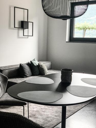 a living room with a table and a couch at Pratenberg Wine Lodge in Merano