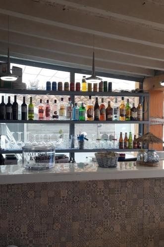 a counter in a kitchen with bottles of alcohol at Apartamentos Marques De La Merced in Málaga
