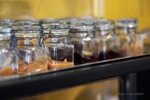 a row of glass jars with food in them at ferme st martin in Manhay