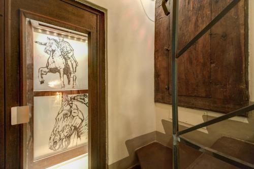 a wooden wall with a painting of a man on it at Residenza Torre Colonna in Rome