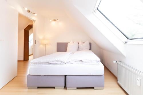 a bedroom with a bed in a attic at Schönebeck Apartment in Essen