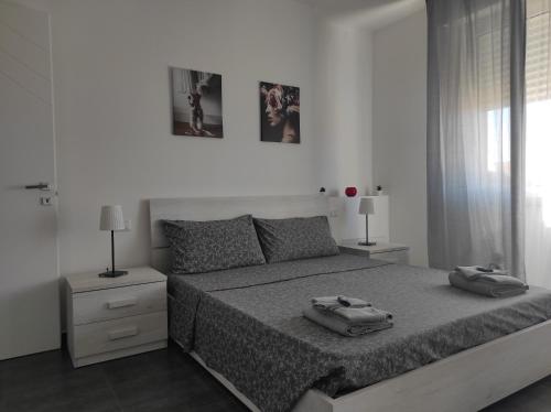 a bedroom with a bed with two towels on it at LA TERRAZZA in Falconara Marittima