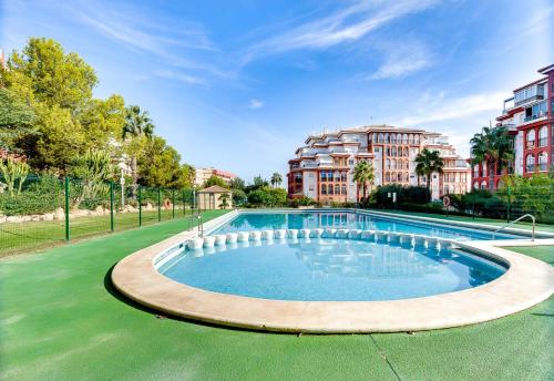 a large swimming pool with buildings in the background at Appartement Torre La Mata in Torrevieja