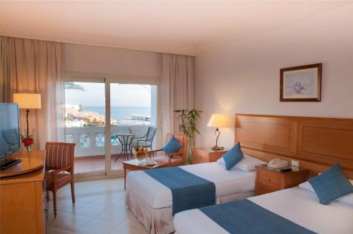 Continental Plaza Beach Resort في شرم الشيخ: غرفة فندقية بسريرين وبلكونة