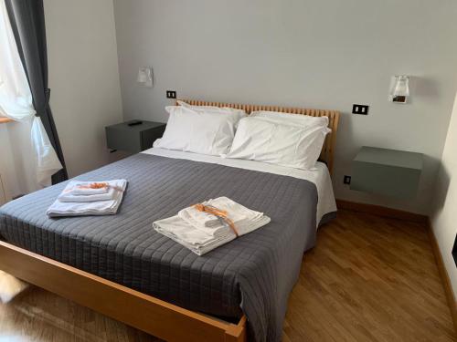 a bedroom with a bed with two towels on it at San Domenico House in Arezzo