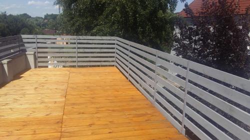 a white fence with a wooden walkway at Penzion David in Třešť