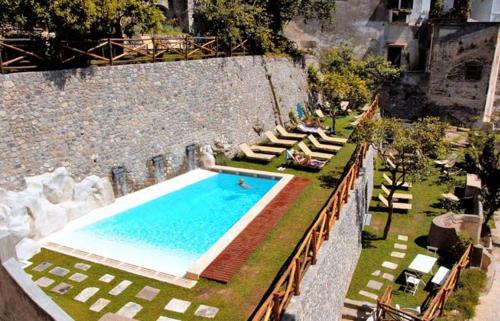 an outdoor swimming pool with chairs at Loft Apartments by AMALFIVACATION in Amalfi