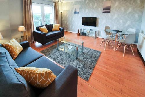 a living room with a couch and a table at Hilton Wynd Apartment in Rosyth