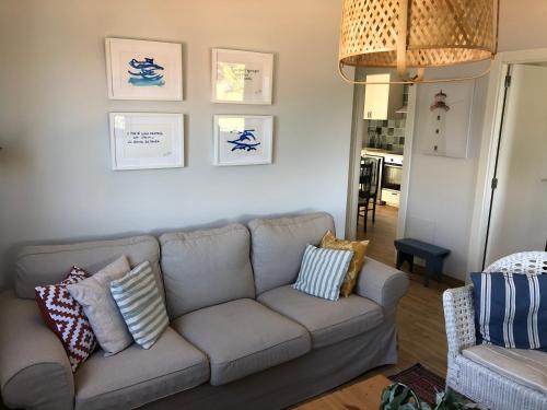 a living room with a gray couch with pillows on it at Villa Balbina in Bueu