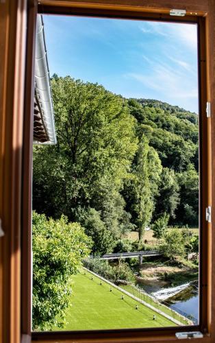 a view from a window of a field of grass and trees at A Casa da Botica in Samos