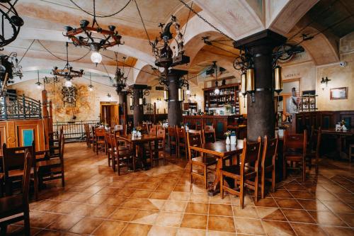 a restaurant with tables and chairs and a bar at Hotel Dar in Prague