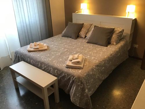 a bedroom with a bed with two towels on it at A casa di Maria in Rome