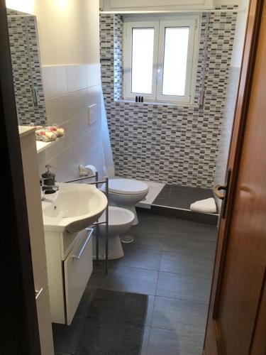 a bathroom with two toilets and a sink at A casa di Maria in Rome
