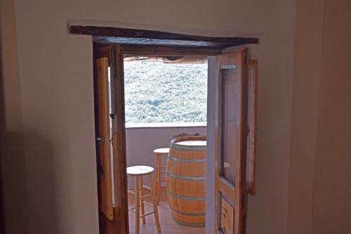 a door to a room with a barrel and a window at Palazzo del Diplomatico in Belmonte Calabro