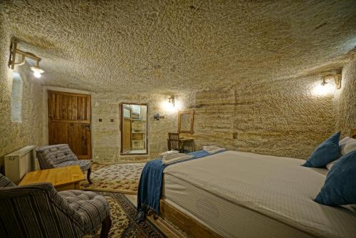 Postel nebo postele na pokoji v ubytování Cappa Cave Hotel