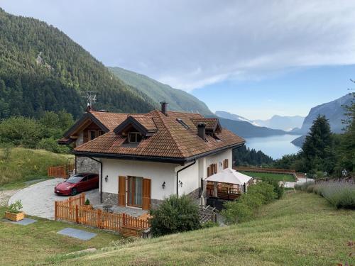 a house with a red car parked in front of it at Agriturismo Ai Castioni in Molveno