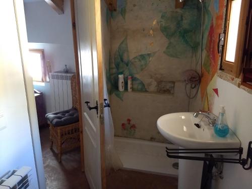 a bathroom with a sink and a shower and a tub at El Retiro de Isabel in Embid de la Ribera