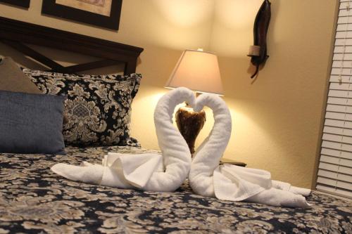 two swans made out of towels on a bed at Viz Cay Apartment 202 in Orlando