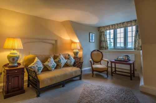 a living room with a couch and a chair at The Talbot Hotel, Oundle , Near Peterborough - The Coaching Inn Group in Oundle