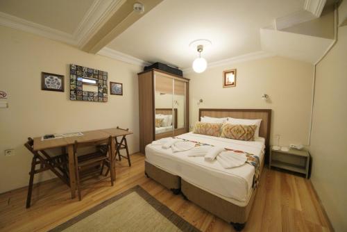 a bedroom with a bed and a desk in it at Topkapi Apartments in Istanbul