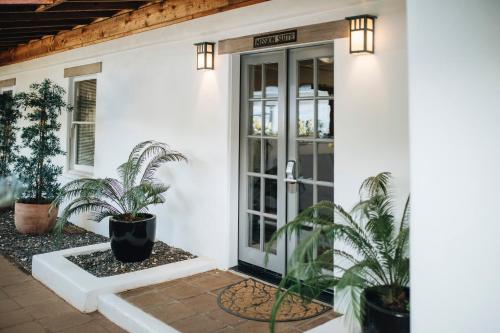 a front door of a white house with plants at Cottage Inn & Spa in Sonoma