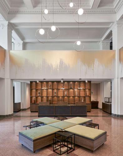 a large room with tables and a painting on the wall at Hyatt Place Chicago Medical/University District in Chicago
