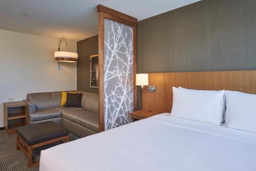 a hotel room with a bed and a couch at Hyatt Place Toronto Mississauga and Luxe Convention Centre in Mississauga