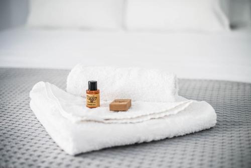 a bottle of soap sitting on top of a white towel at Carlos Pension in Akrotiri