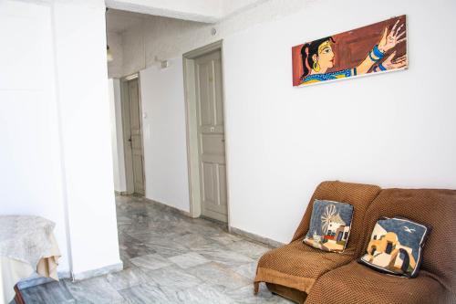 a living room with a chair and a painting on the wall at Carlos Pension in Akrotiri