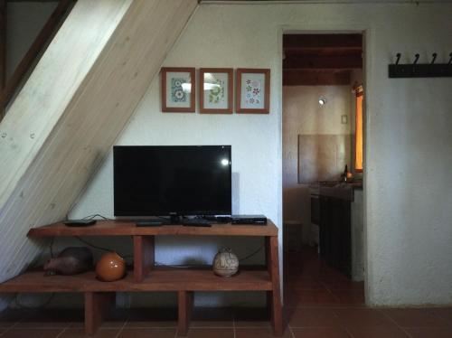 a television on a wooden table in a room at Al Sur in La Paloma