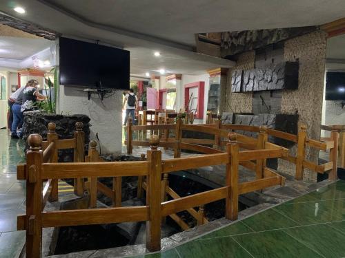 a church with wooden pews and a tv on a wall at Hotel Alameda in Orizaba